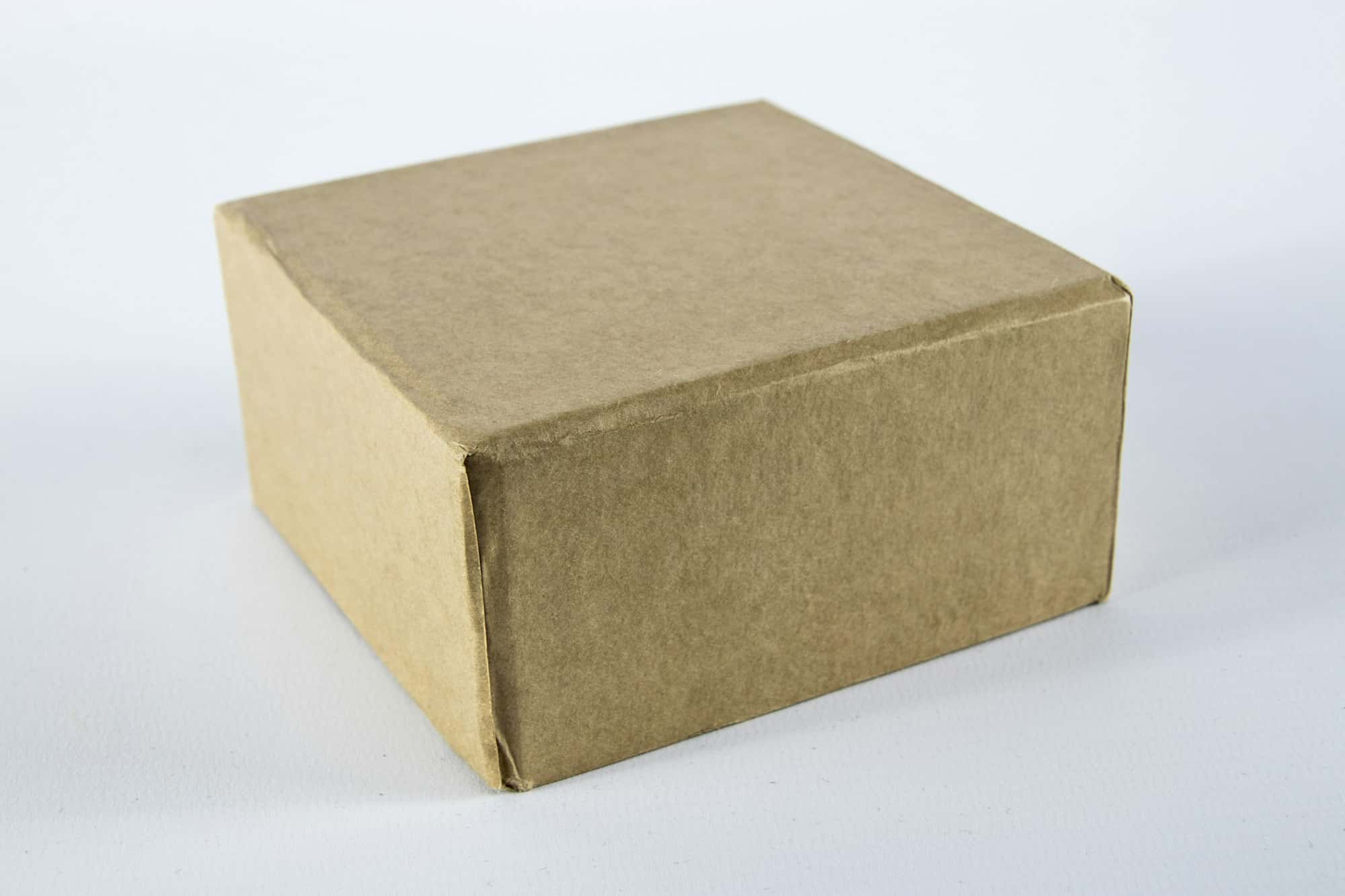 A brown cardboard shipping box on a white surface